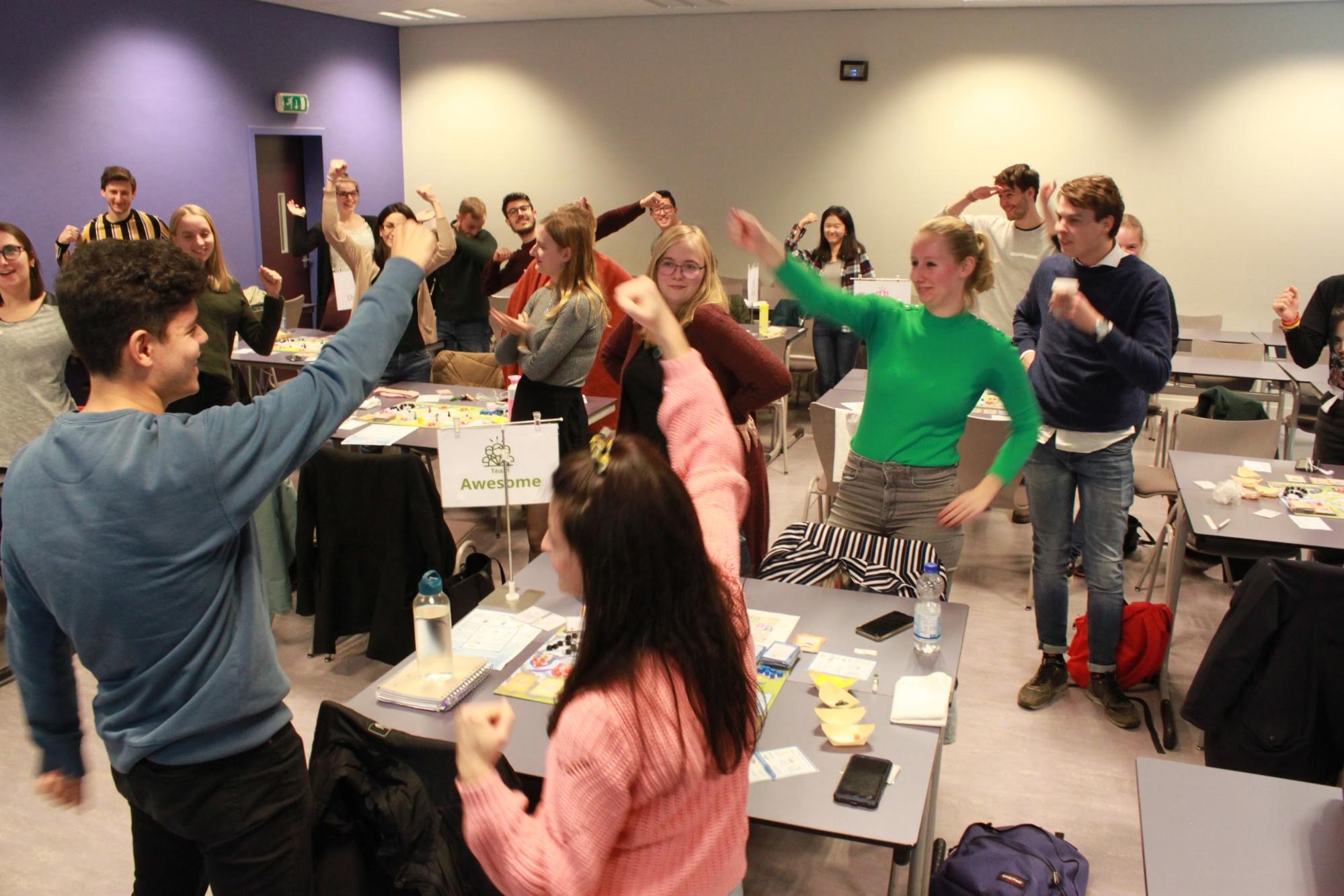 Excited students teambuilding while playing a climate game.